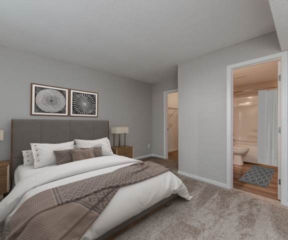A bedroom with a large bed and two lamps.