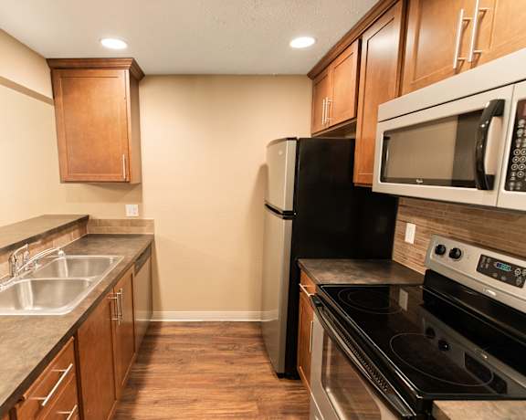 A kitchen with a black refrigerator and stove at Graymayre Crossing Apartments, Spokane, WA, 99208