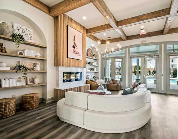 a living room with a large white couch and a fireplace