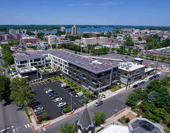 an aerial view of a city with buildings and a river in the background at The Rail at Red Bank, Red Bank, 07701