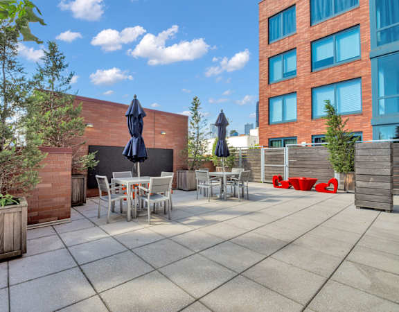 a patio with tables and chairs and umbrellas