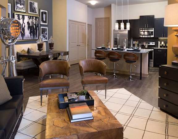 a living room with a kitchen and a table with chairs