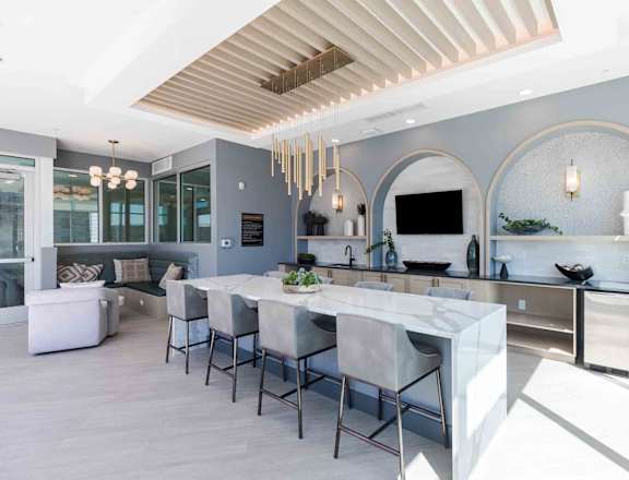 a large kitchen with a marble counter top and a dining table