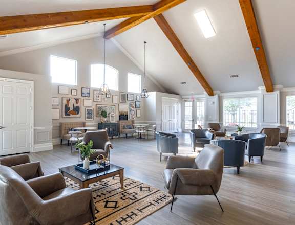 a large living room with couches chairs and a table