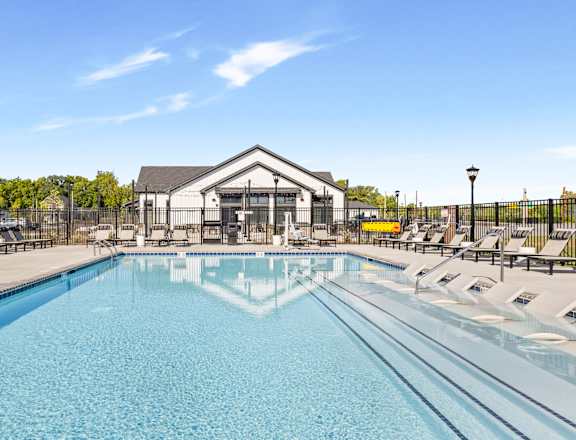 A large swimming pool with a building in the background.
