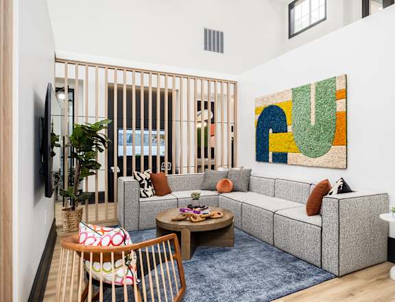 a living room with a couch and a table and a rug