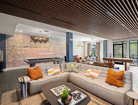 a living room with a couch and a pool table