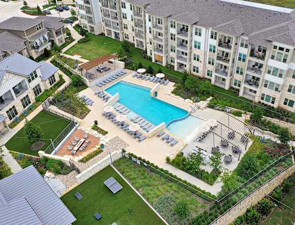 an aerial view of an apartment building with a swimming pool