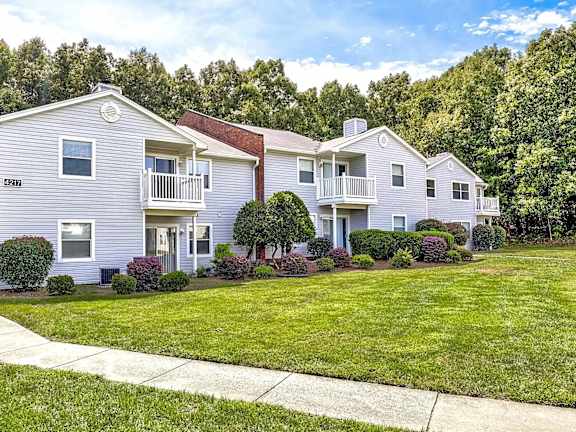 A row of houses with green lawns in front at Sedgefield Square Apartments, North Carolina, 27407
