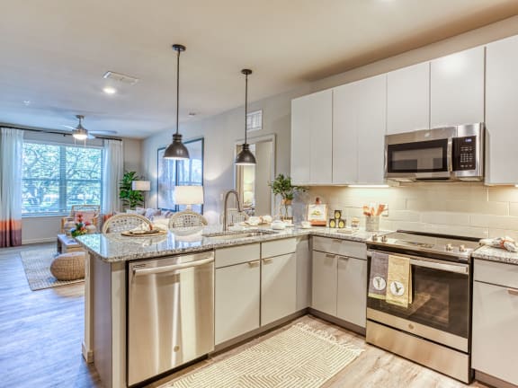a kitchen with stainless steel appliances and granite counter tops at The Beck at Hidden River, Tampa, FL, Florida