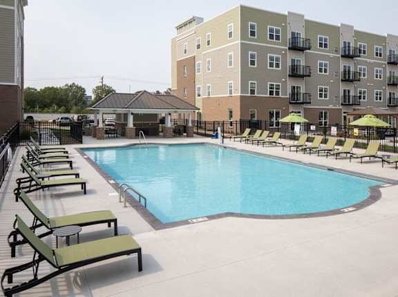 A large swimming pool surrounded by sun loungers and umbrellas. at The Edison at Rice Creek I and II, Minnesota, 55126