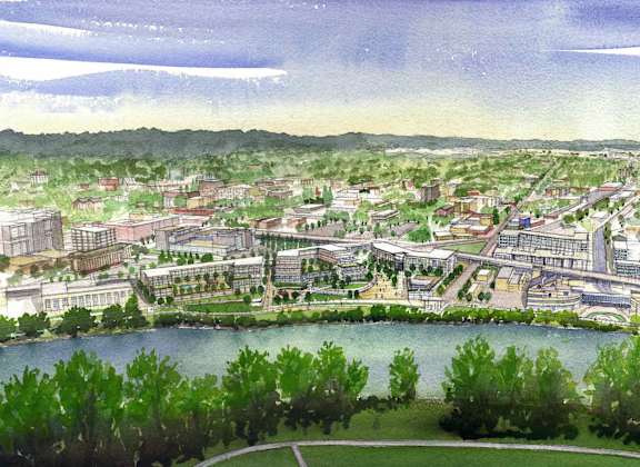 A waterfront city with a large building in the center.