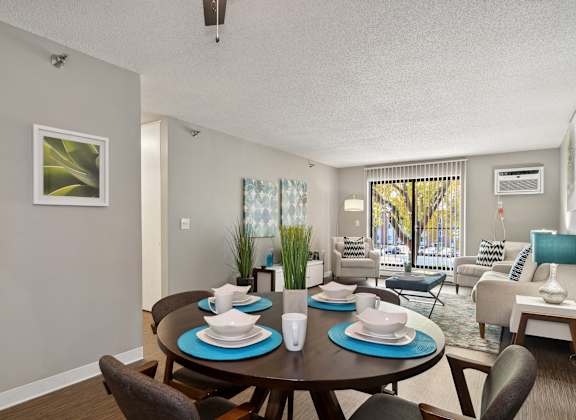 A dining room with a table set for four.