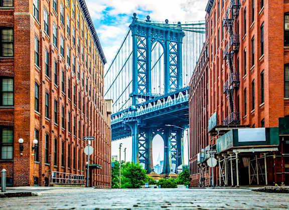 A bridge spans the distance between two rows of buildings.