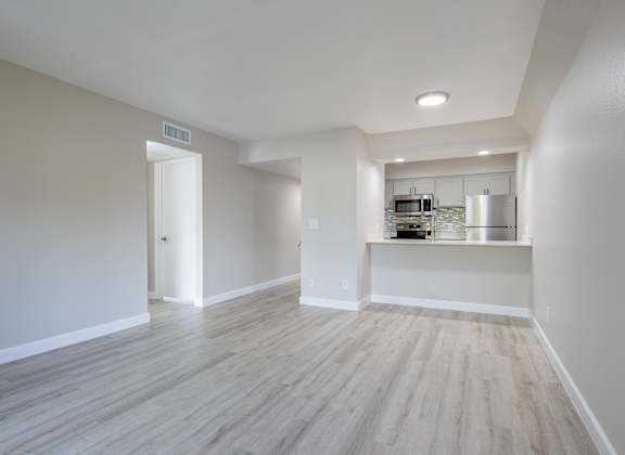 A kitchen area with a countertop and cabinets is visible through a doorway. at Sofia Apartments, Tempe, AZ, 85283