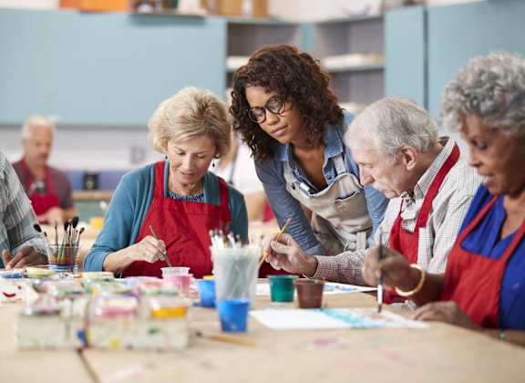 a group of people doing arts and crafts at a table