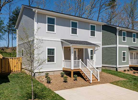 A two story house with a grey and white exterior.