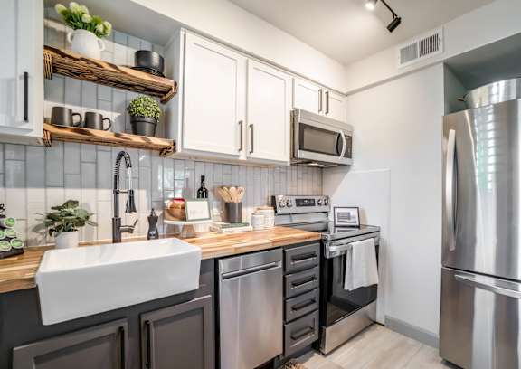 a kitchen with granite counter tops and stainless steel appliances at Kiwi Goji Apartments, Memphis