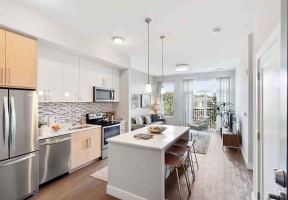 A modern kitchen with stainless steel appliances and wooden cabinets.