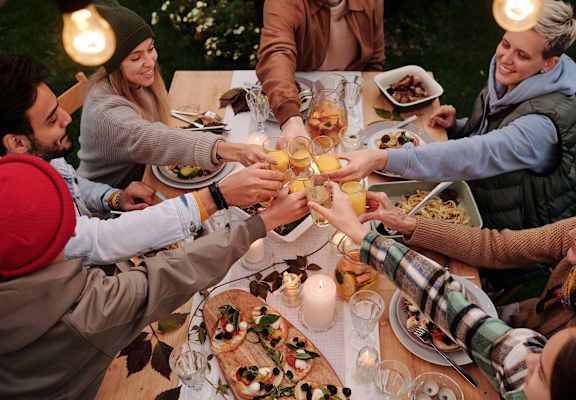 a group of people making a toast at a dinner table