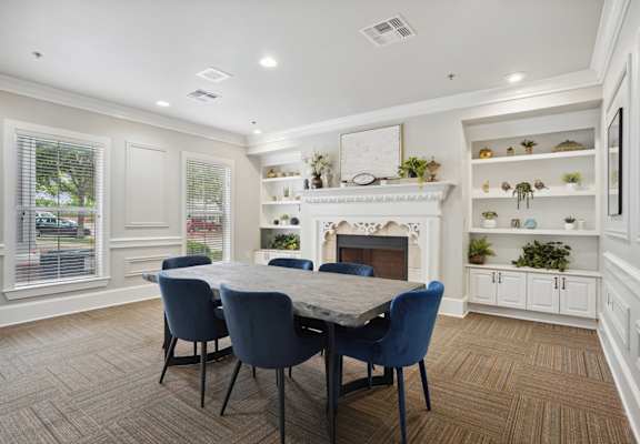 a dining room with a table and chairs in front of a fireplace