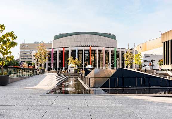 a large building with a fountain in front of it