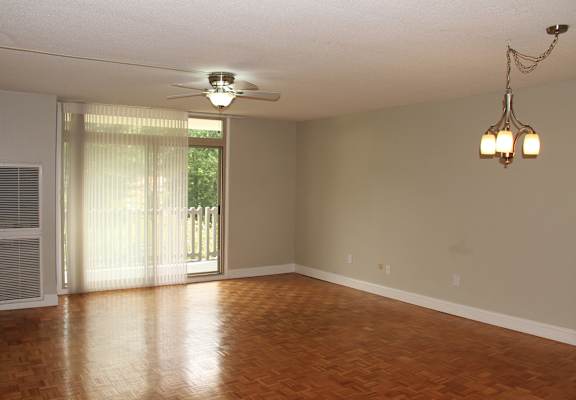 an empty living room with wood floors and a ceiling fan at Renew Worcester, Massachusetts, 01602