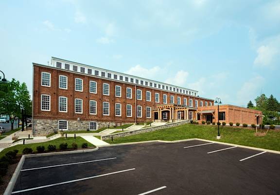 a large brick building with a parking lot