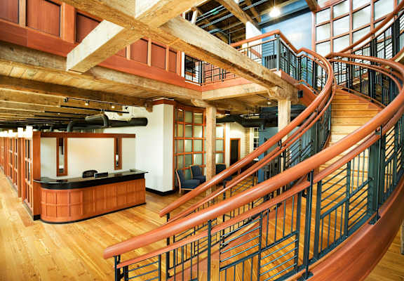 a large lobby with stairs and a reception desk