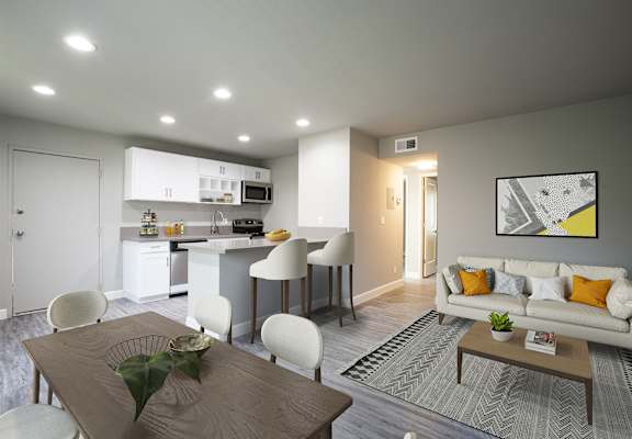A modern living room with a dining table and chairs.