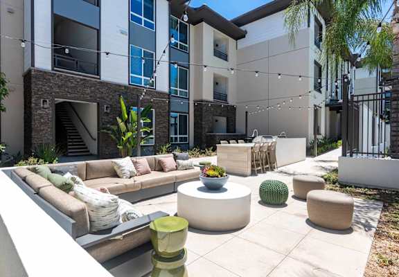 A modern outdoor seating area with a variety of seating options and plants.