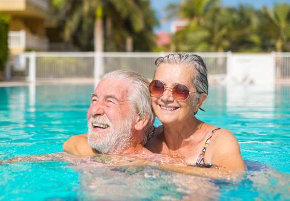 an older man and woman in a swimming pool
