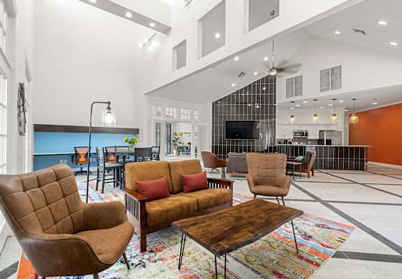 A living room with a brown chair and a brown couch.