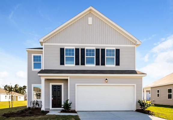a white house with a garage door in front of it