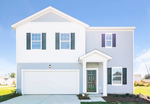 a white house with blue shutters and a driveway