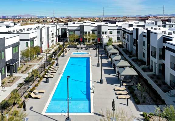 an aerial view of an apartment complex with a large swimming pool