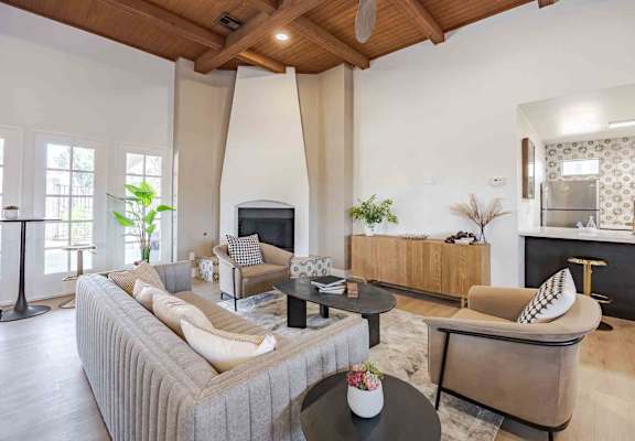 A living room with a grey sofa and a black coffee table.