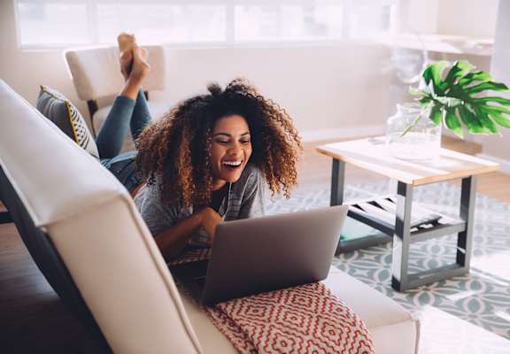 stock photography of woman on laptop looking at apartments
