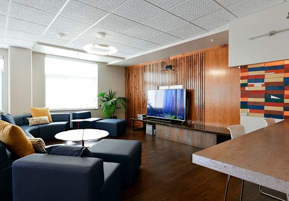 A modern living room with a television and a sofa.