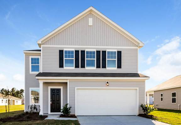 a white house with a garage door in front of it