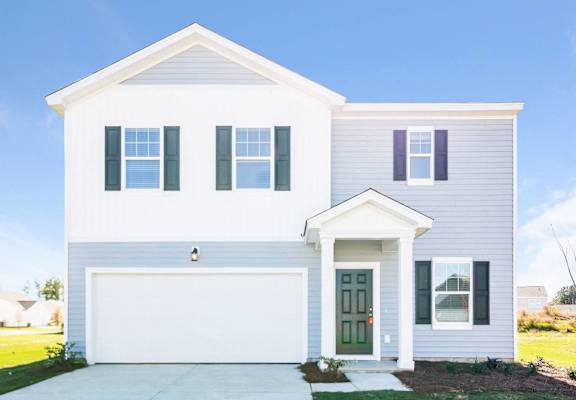 a white house with blue shutters and a driveway