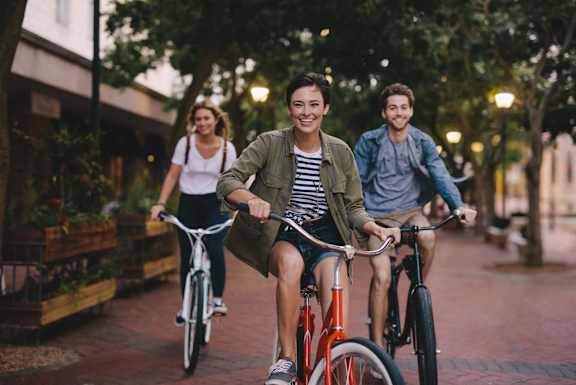a group of people riding bikes down a street at South Falls Tower, Richmond, VA, 23224
