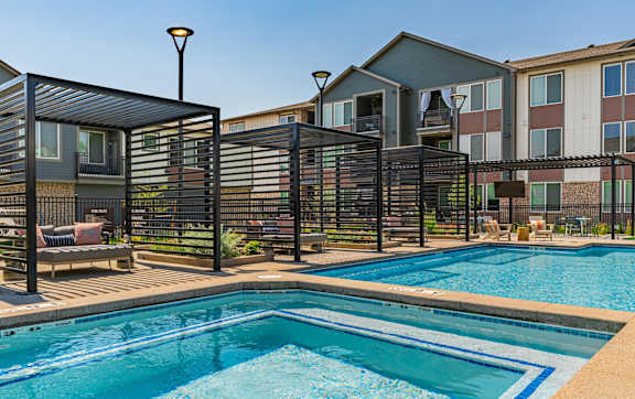 A large swimming pool in front of a building.