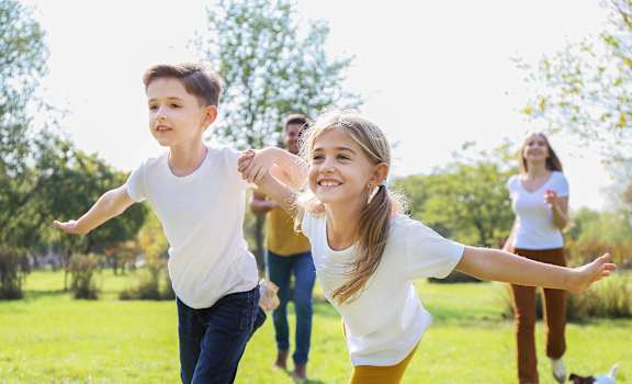 a group of people playing in the park
