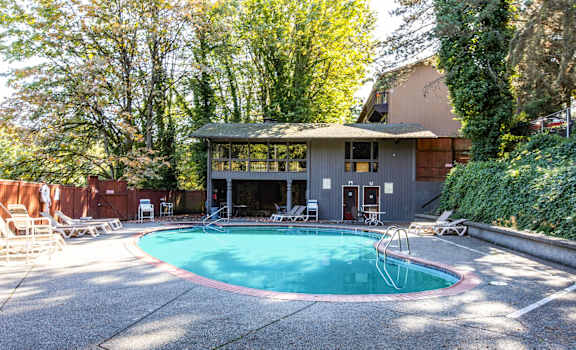 a swimming pool in front of a house at Whisperwood, Seattle, 98168