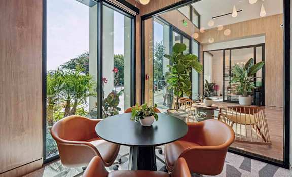A modern dining area with a round table and chairs.
