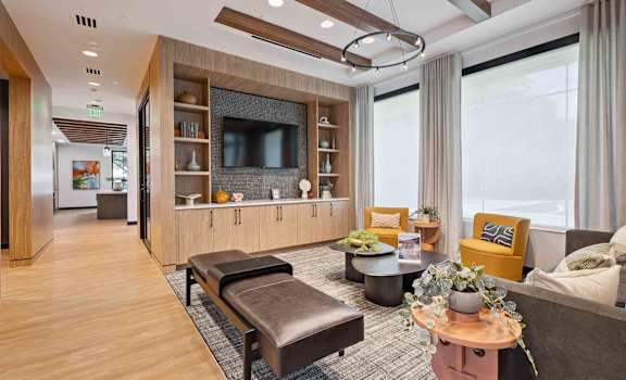 A modern living room with a wooden floor and a large window.