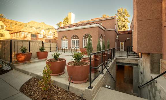 A courtyard with a building and potted plants.at 891 Exchange, Boulder, CO