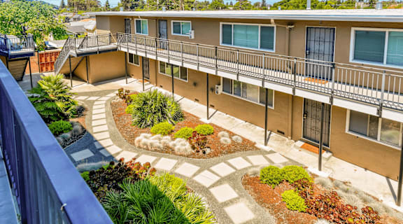 an overview of the courtyard of a building with plants and walkways