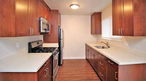 a kitchen with wooden cabinets and a stove and refrigerator